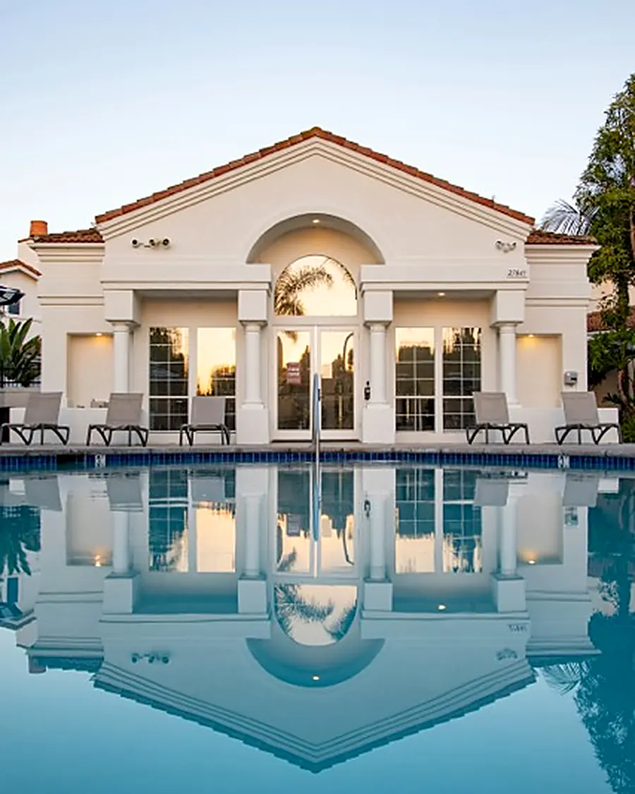 Residential clubhouse and pool at dusk