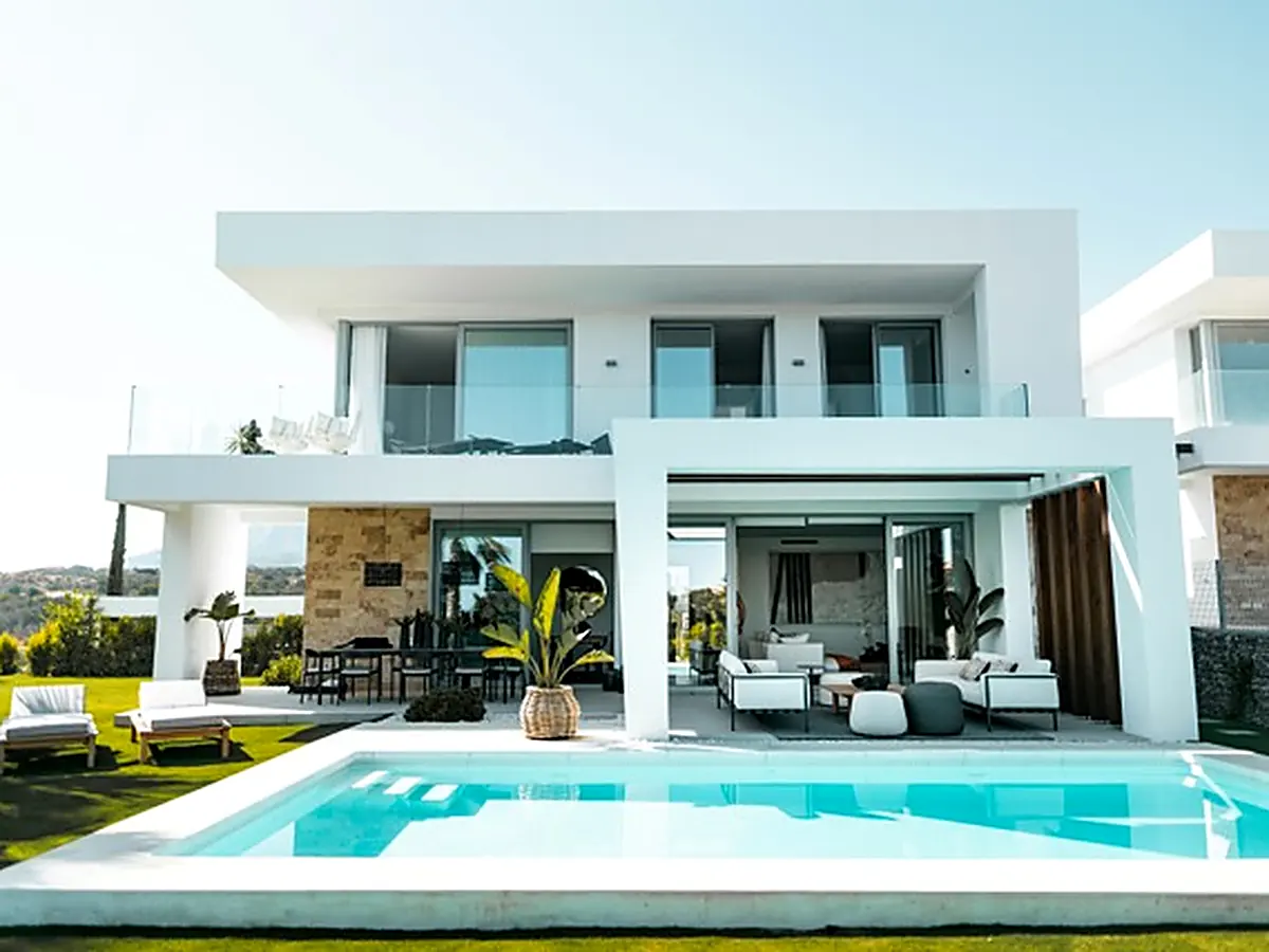 Contemporary white villa with a pool and covered outdoor living area