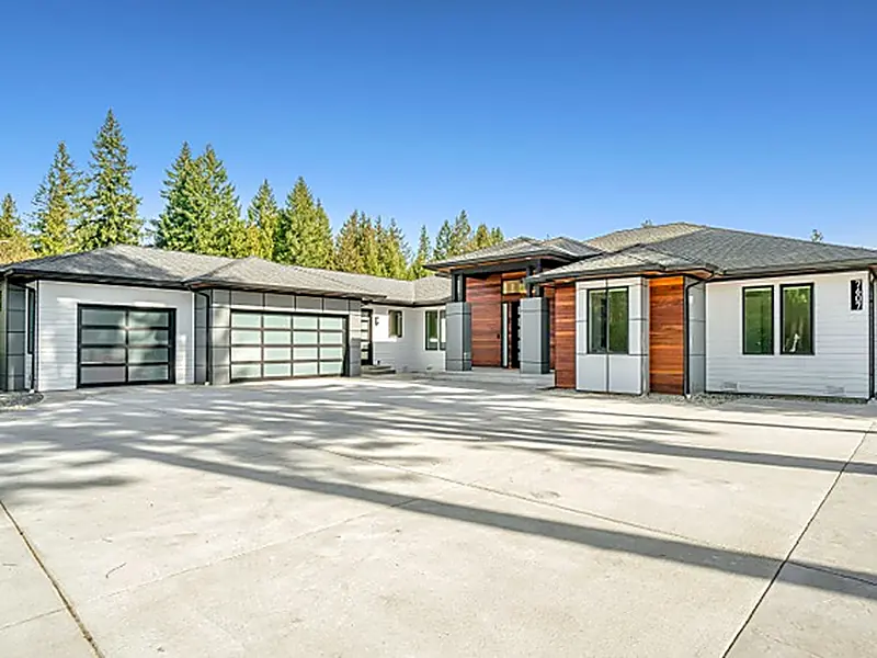Modern single storey home with a wide concrete driveway and three garage bays